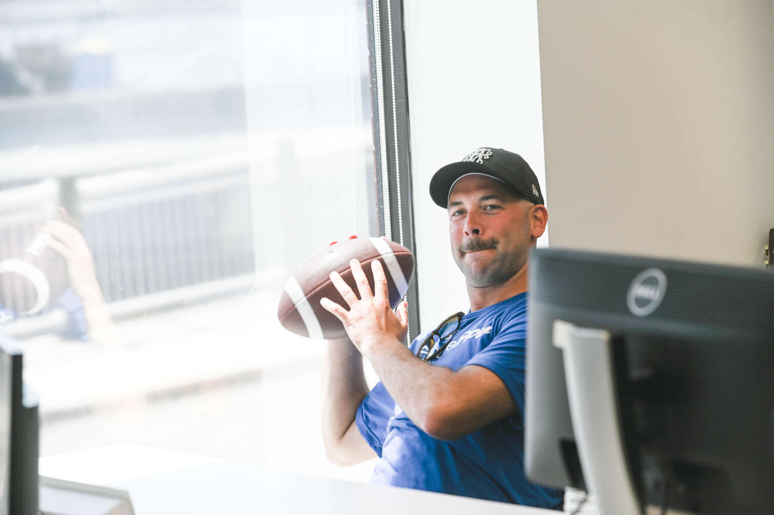 PF team playing american football in the office